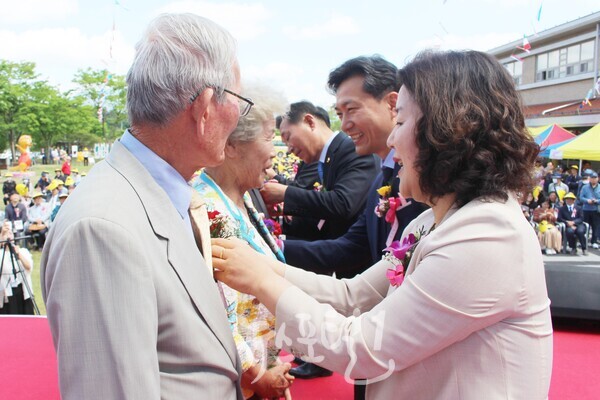 정경남 효령노인복지타운 본부장이 기광주 어르신에게 카네이션을 달아드리고 있다.