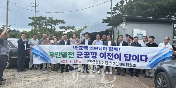 간담회가 끝난 뒤 이창준 부위원장의 선창으로 구호를 외치고 있는 박균택 국회의원과 「무안 군 공항 이전 원주민 대책위원회」 회원 등 참석자들 모습.