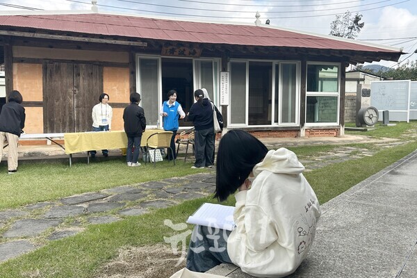 윤상원 열사 생가에서 글을 짓는 학생의 모습도. 정면에 보이는 건물이 윤상원 열사 생가 사랑채 해파재(海波齋)이다.